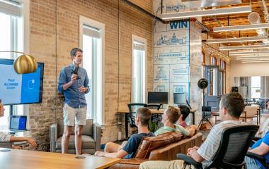 One person presenting to the group of people